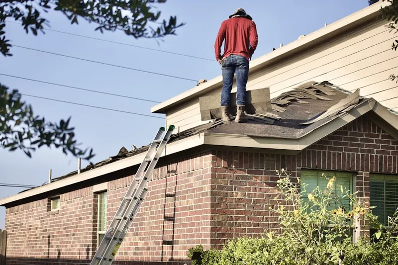 Professional roofer working on a residential roof in Groves